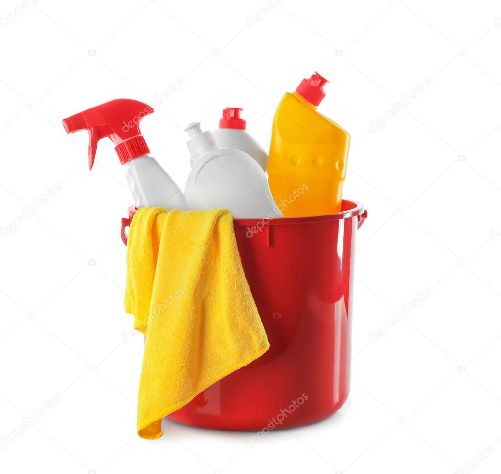 Plastic bucket with different cleaning products and rag on white background