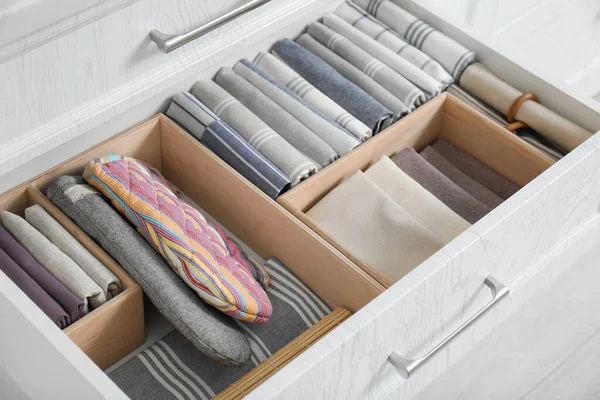 Open drawer with different textiles in kitchen, above view