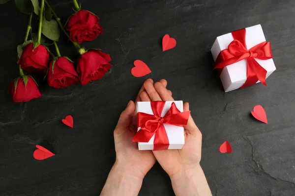 Woman Holding Gift Box Black Table Top View Valentine Day — Stock Photo, Image