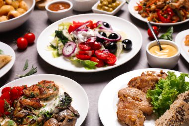 Büfe servisi. Gri masada bir sürü farklı yemek var.
