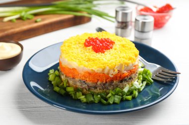 Beyaz masada servis edilen geleneksel Rus salatası Mimosa.