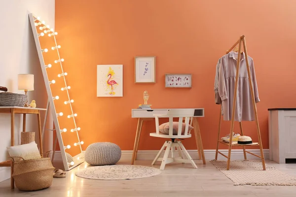 Trendy mirror with light bulbs in stylish room interior