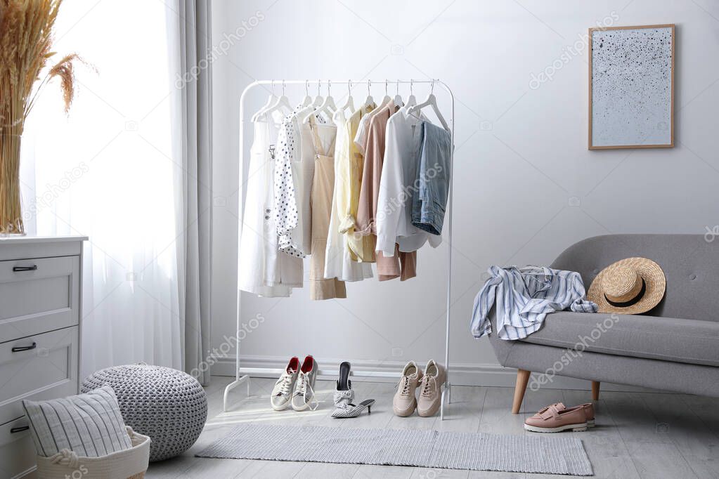 Dressing room interior with clothing rack and sofa