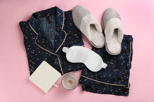 Composition with house slippers, sleeping mask and pajamas on pink background, flat lay