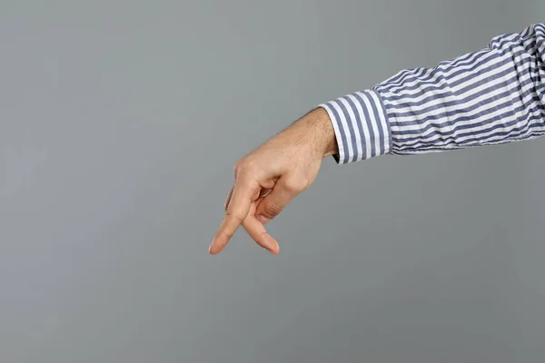 Hombre Imitando Caminar Con Mano Sobre Fondo Gris Primer Plano —  Fotos de Stock