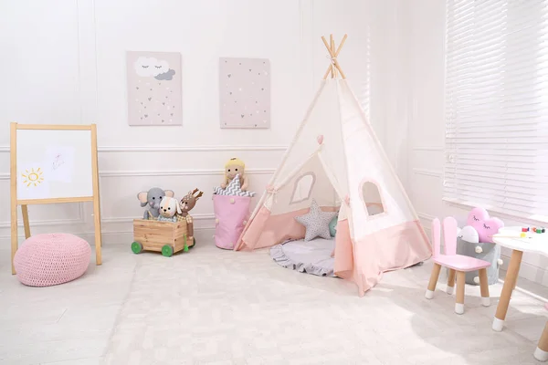 Cute child\'s room interior with toys, modern furniture and play tent