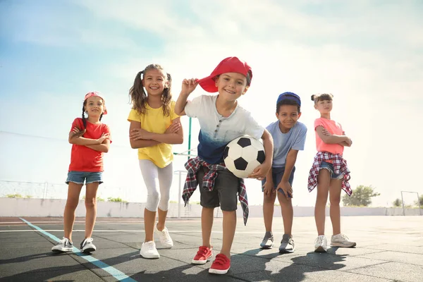 晴れた日にはスポーツコートでサッカーボールを持つかわいい子供たち サマーキャンプ — ストック写真