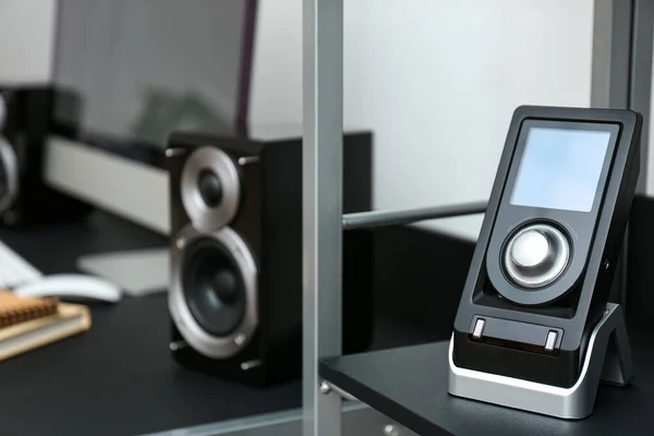 Modern audio speaker and remote control indoors