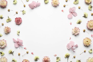 Frame of different fresh and dry flowers on white background, flat lay. Space for text clipart