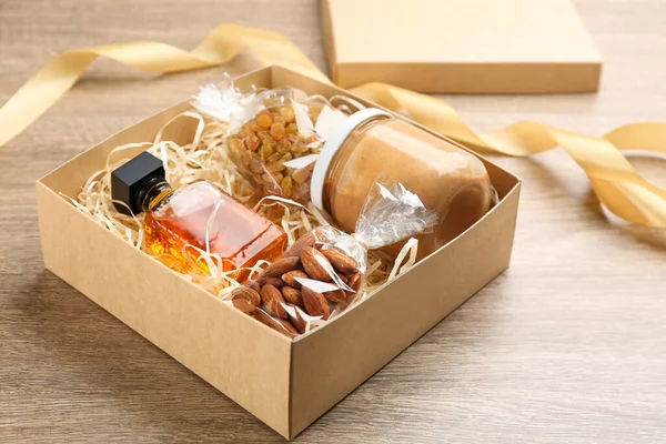 Stylish gift set in box on wooden table