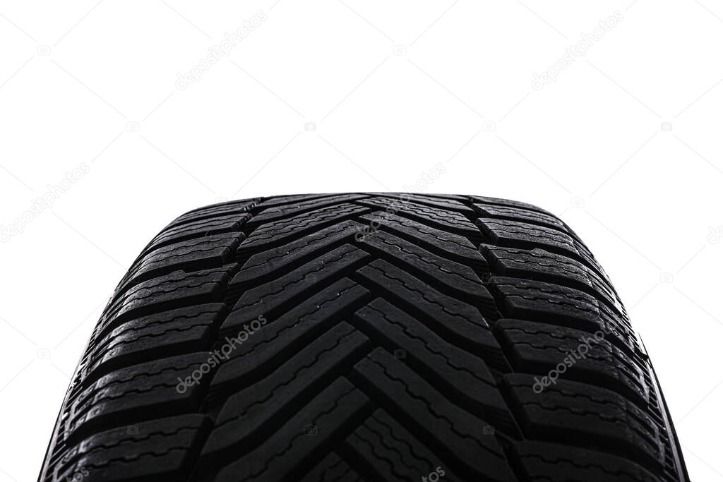 Winter tire on white background, closeup. Car maintenance