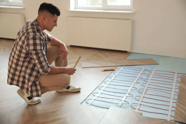 Professional Worker Installing Electric Underfloor Heating System Indoors — Stock Photo, Image