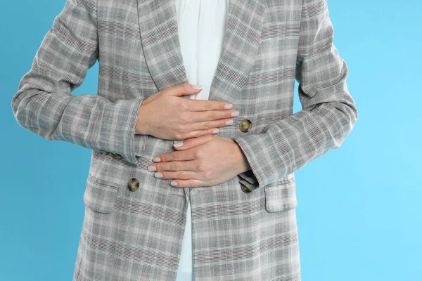 Woman Office Suit Suffering Stomach Ache Light Blue Background Closeup — Stock Photo, Image