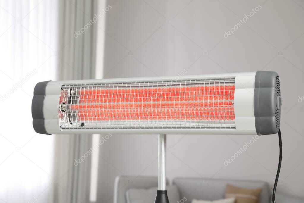 Modern electric infrared heater in living room