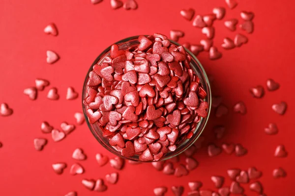 Bright Heart Shaped Sprinkles Glass Bowl Red Background Flat Lay — Stock Photo, Image