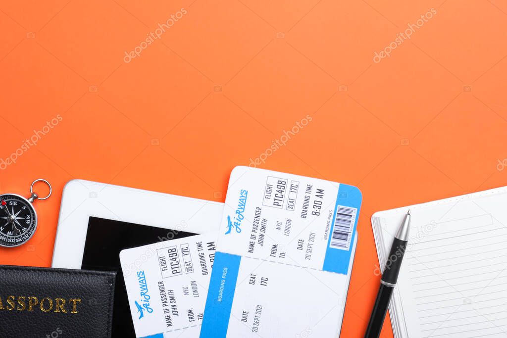 Flat lay composition with avia tickets on orange background, space for text. Travel agency concept