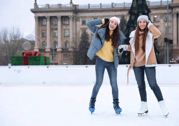 幸せな女性は屋外でアイスリンクに沿ってスケート テキストのスペース — ストック写真