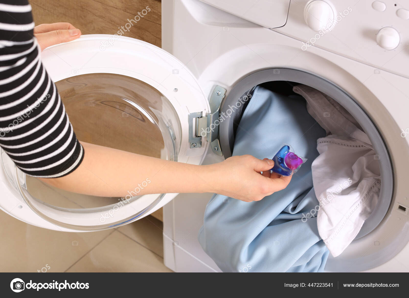 Woman Putting Laundry Detergent Capsule Washing Machine Indoors Closeup