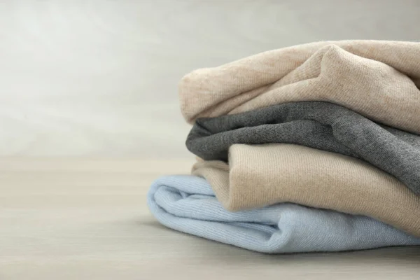 Stack Cashmere Clothes Wooden Table Space Text — Stock Photo, Image