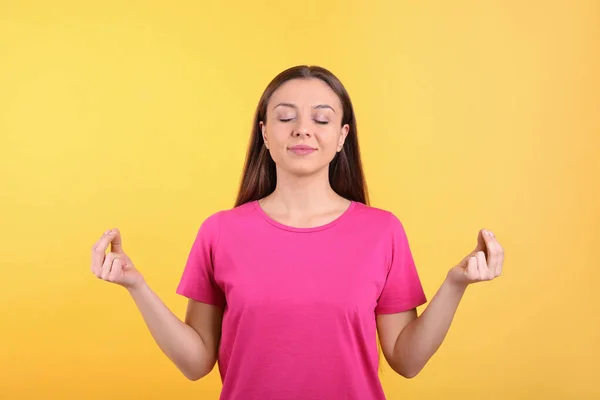 Jovem Mulher Meditando Sobre Fundo Amarelo Exercício Alívio Estresse — Fotografia de Stock