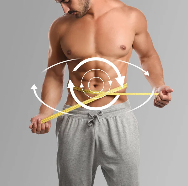 Metabolism concept. Man with perfect body on light grey background