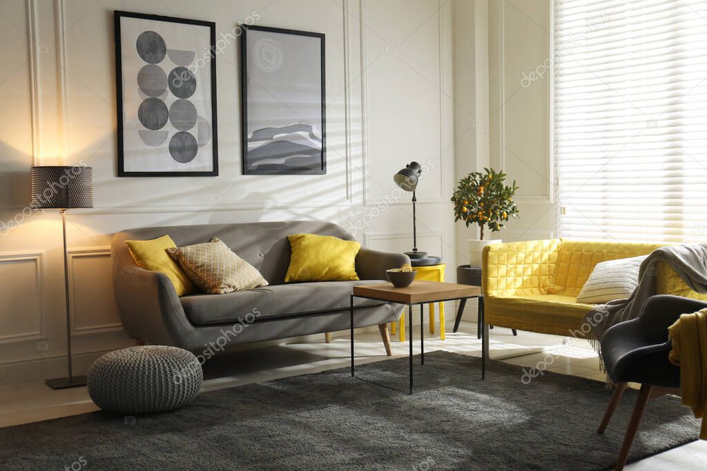 Stylish living room with sofas. Interior design in grey and yellow colors