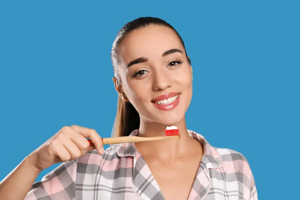 Mujer Sosteniendo Cepillo Dientes Con Pasta Sobre Fondo Azul —  Fotos de Stock