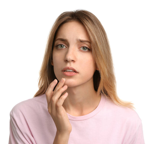 Woman with herpes applying cream onto lip against white background