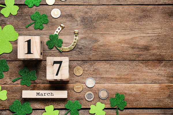 Flat lay composition with block calendar on wooden table, space for text. Saint Patrick's Day celebration