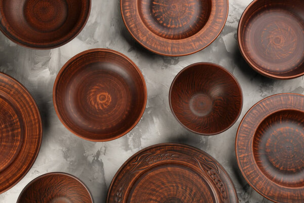 Set of clay dishes on grey table, flat lay