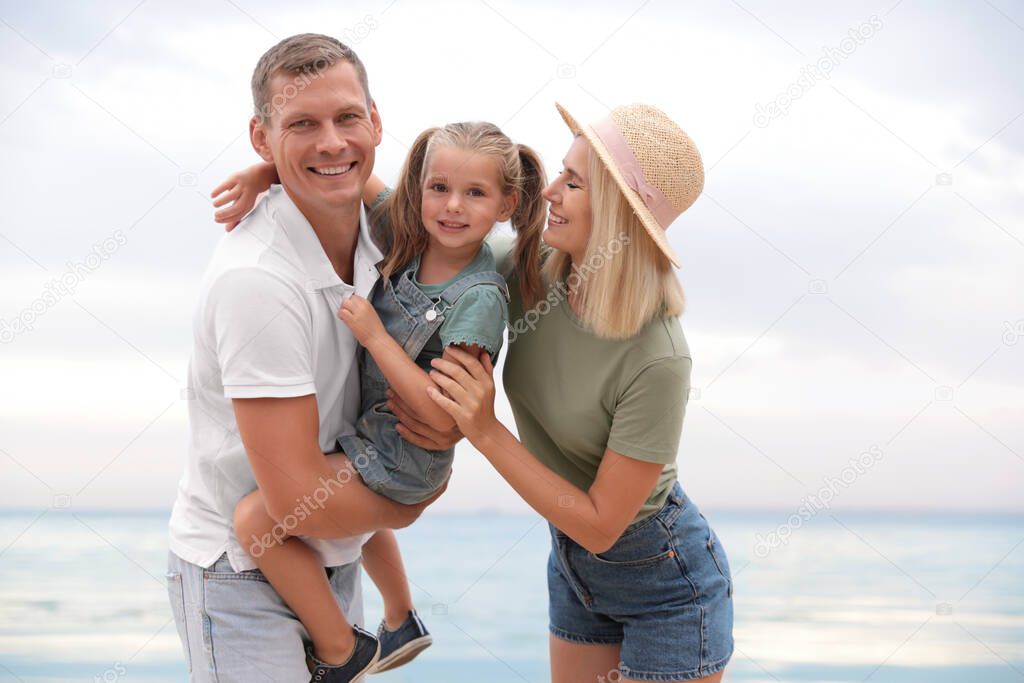 Happy family near sea on sunny summer day