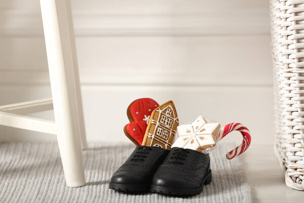 Sweets in child's shoes indoors, space for text. St. Nicholas Day tradition