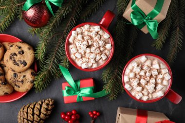 Düz kompozisyon ve siyah masanın üzerinde lezzetli sıcak kakao.