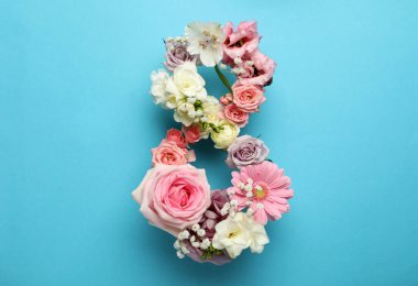 Açık mavi arka planda güzel çiçeklerden yapılmış 8 numara, düz yatıyordu. Uluslararası Kadınlar Günü