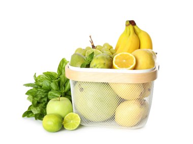 Beyaz arka planda sepette taze egzotik meyveler var.