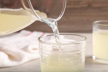 Sürahiden bardağa taze taze meyve suyu dökerek.