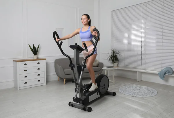 Happy Young Woman Training Elliptical Machine Home — Stock Photo, Image