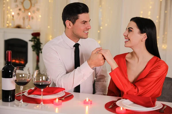 Happy couple having romantic dinner on Valentine\'s day in restaurant