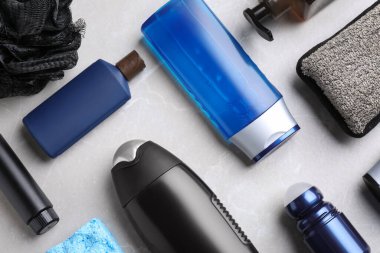 Açık gri mermer arka planda erkek kozmetiği olan düz bir kompozisyon.