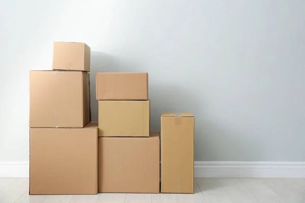 Cardboard boxes with stuff indoors, space for text. Moving day