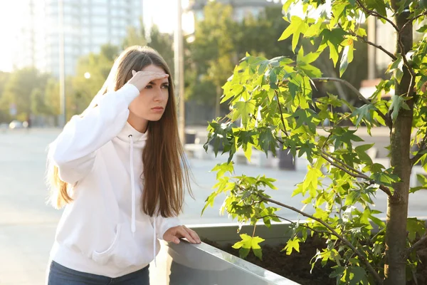 Jealous woman spying on ex boyfriend outdoors