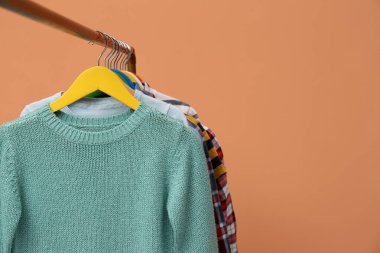 Bej arka planda şık çocuk kıyafetleri, yakın plan. Metin için boşluk