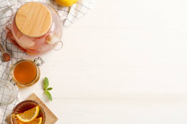 Düz kompozisyon ve beyaz ahşap masa üzerinde sıcak çay. Metin için boşluk