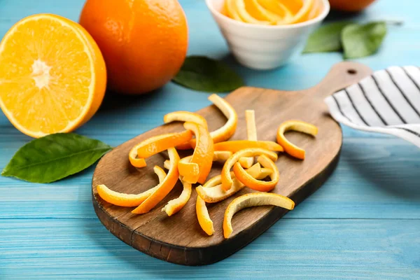 Orange peels on light blue wooden table