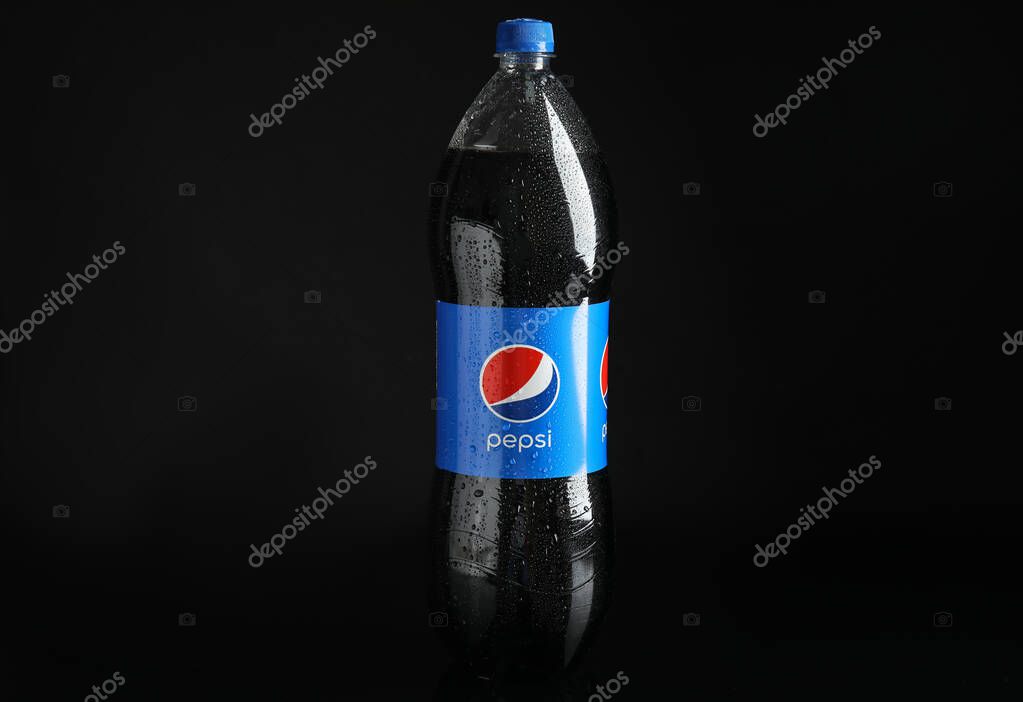 MYKOLAIV, UKRAINE - FEBRUARY 9, 2021: Bottle of Pepsi on black background
