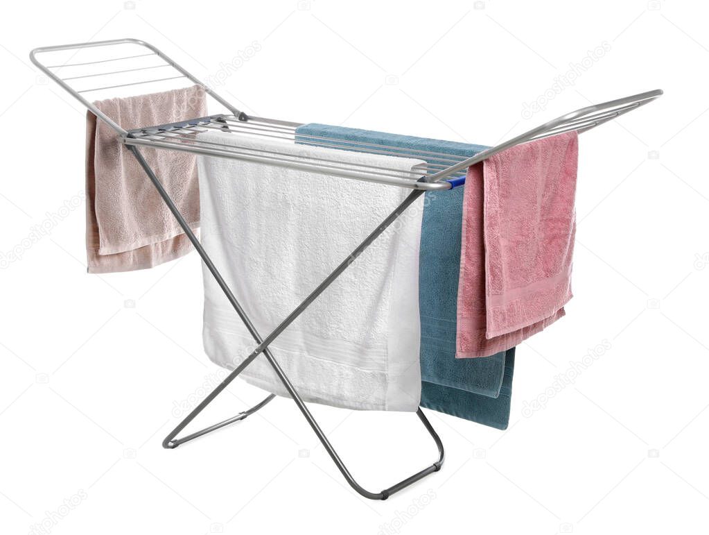 Modern drying rack with towels on white background