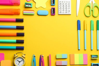 Sarı arka planda farklı okul kırtasiyesi çerçevesi, mesaj için yeri olan düz bir tabaka. Okula geri dön.