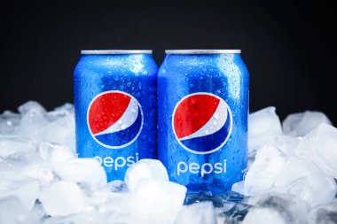 MYKOLAIV, UKRAINE - 11 Şubat 2021: Siyah arkaplana karşı buz küpleri üzerinde Pepsi kutuları