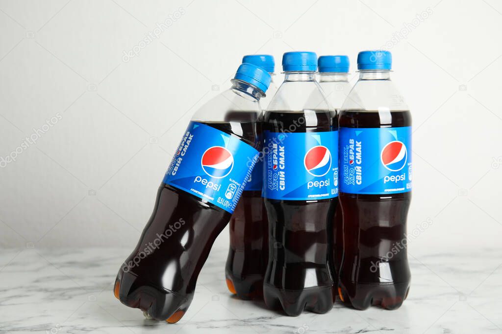 MYKOLAIV, UKRAINE - FEBRUARY 9, 2021: Many bottles of Pepsi on white marble table