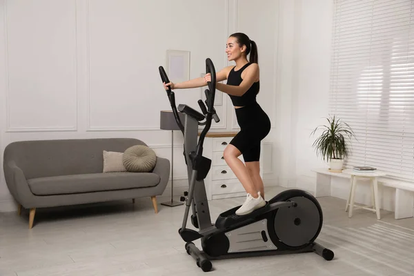 Happy Young Woman Training Elliptical Machine Home — Stock Photo, Image